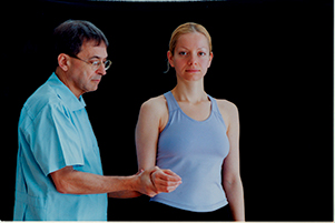 Therapist performing a resisted lateral rotation test on client 