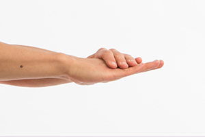 Person holding right hand out with palm down and left hand on top of right hand