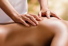 Massage therapist massaging a client's back.