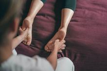 Massage therapist giving a client a foot massage 